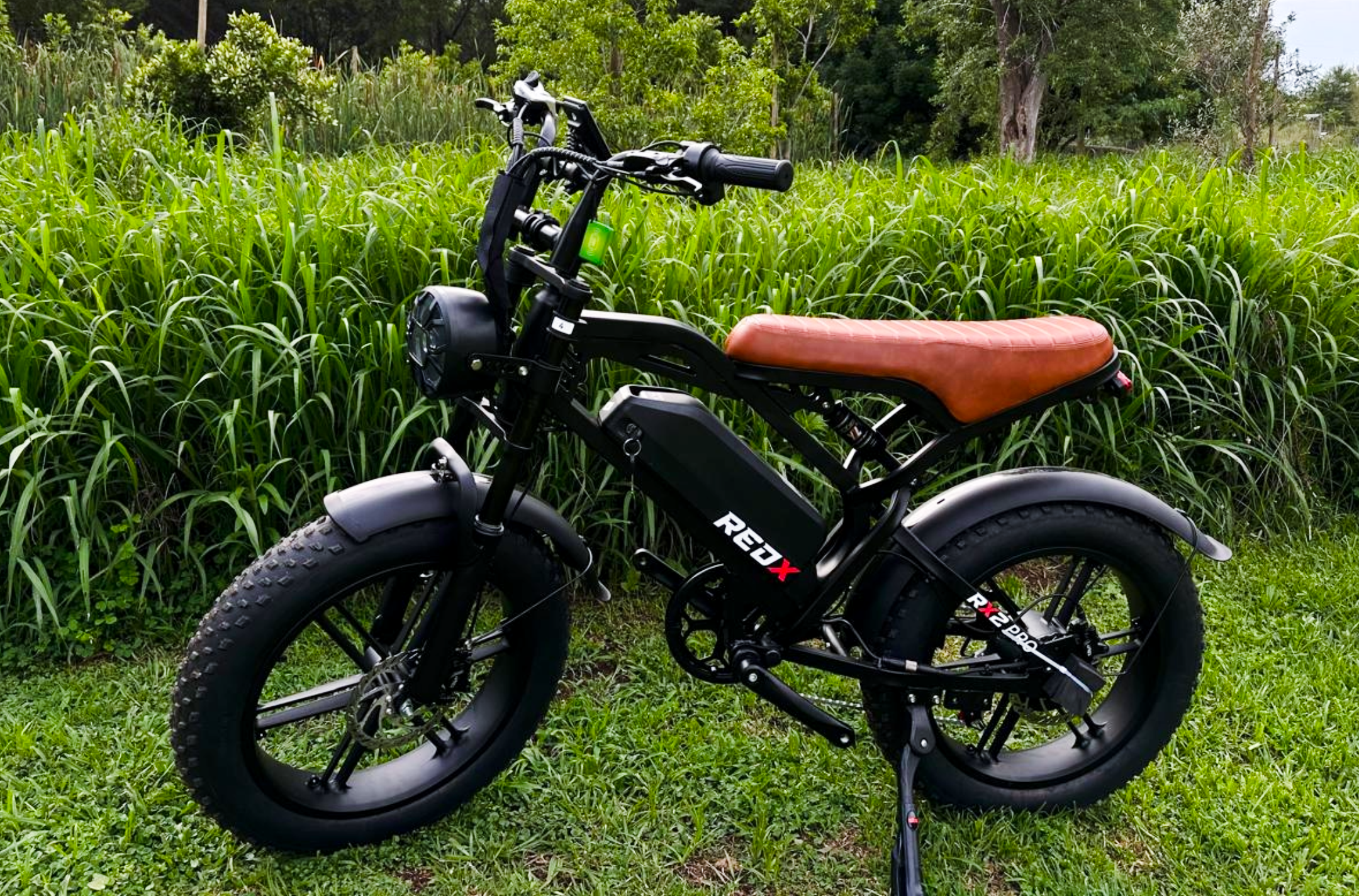Red X RX2 Pro fat bike ebike with brown leather seat on grass